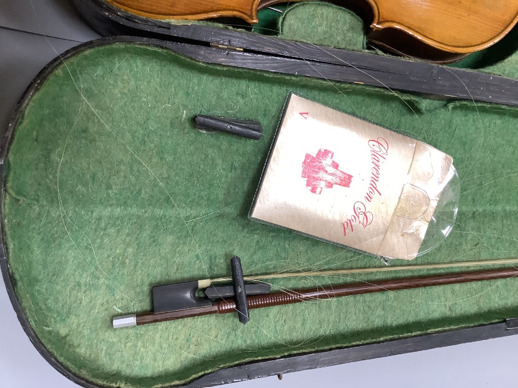 An early 20th century violin, unlabelled case, with bow, length 60cm